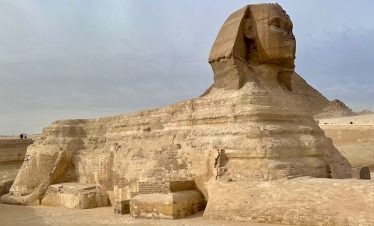 Majestic view of the Great Sphinx in Giza, showcasing ancient Egyptian architecture under a bright sky.