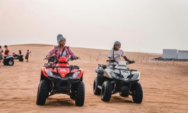 Mother and Son Riding Quads on Desert